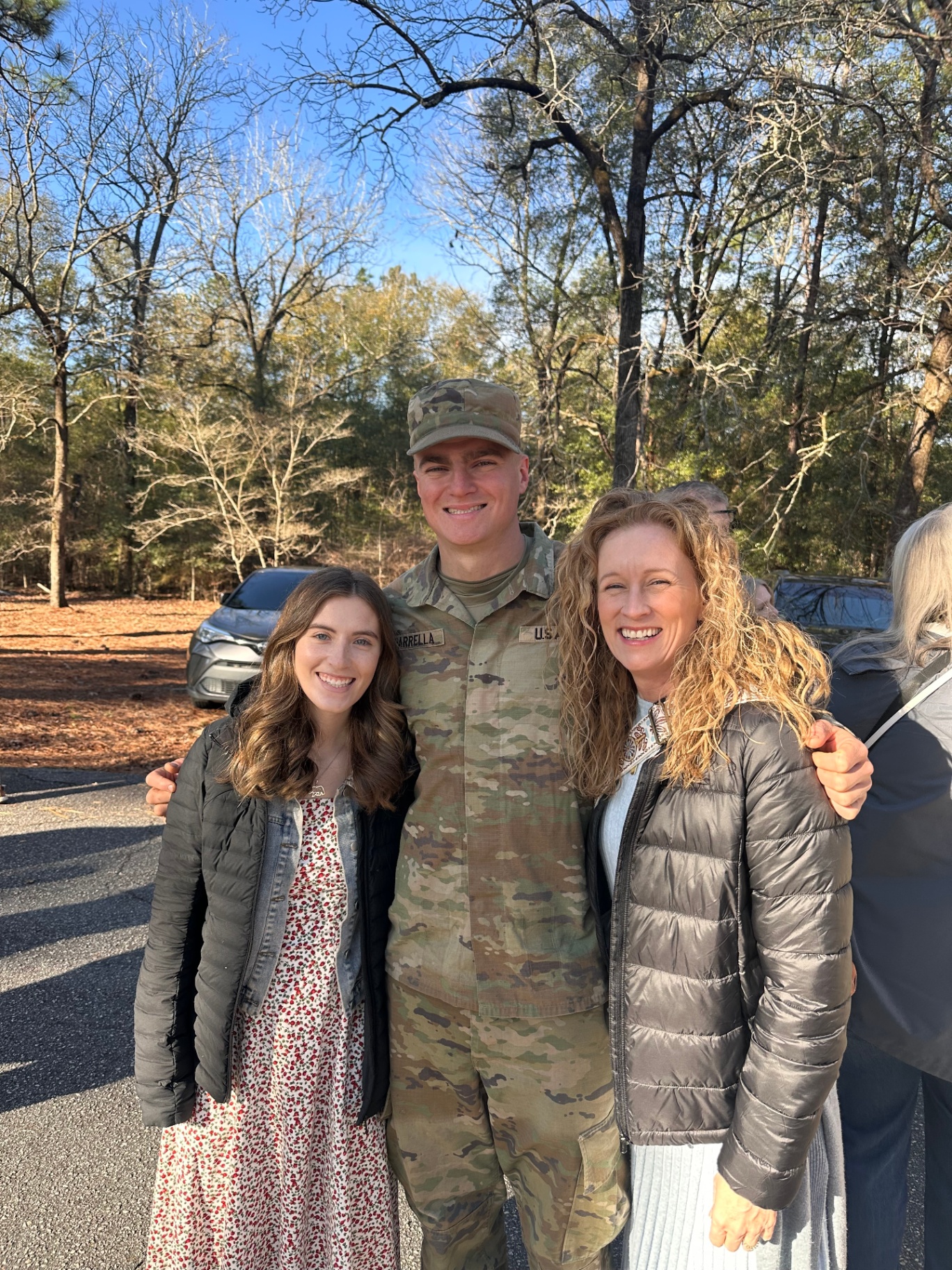 Sydney, Jennifer, and Sydney's service member together outdoors