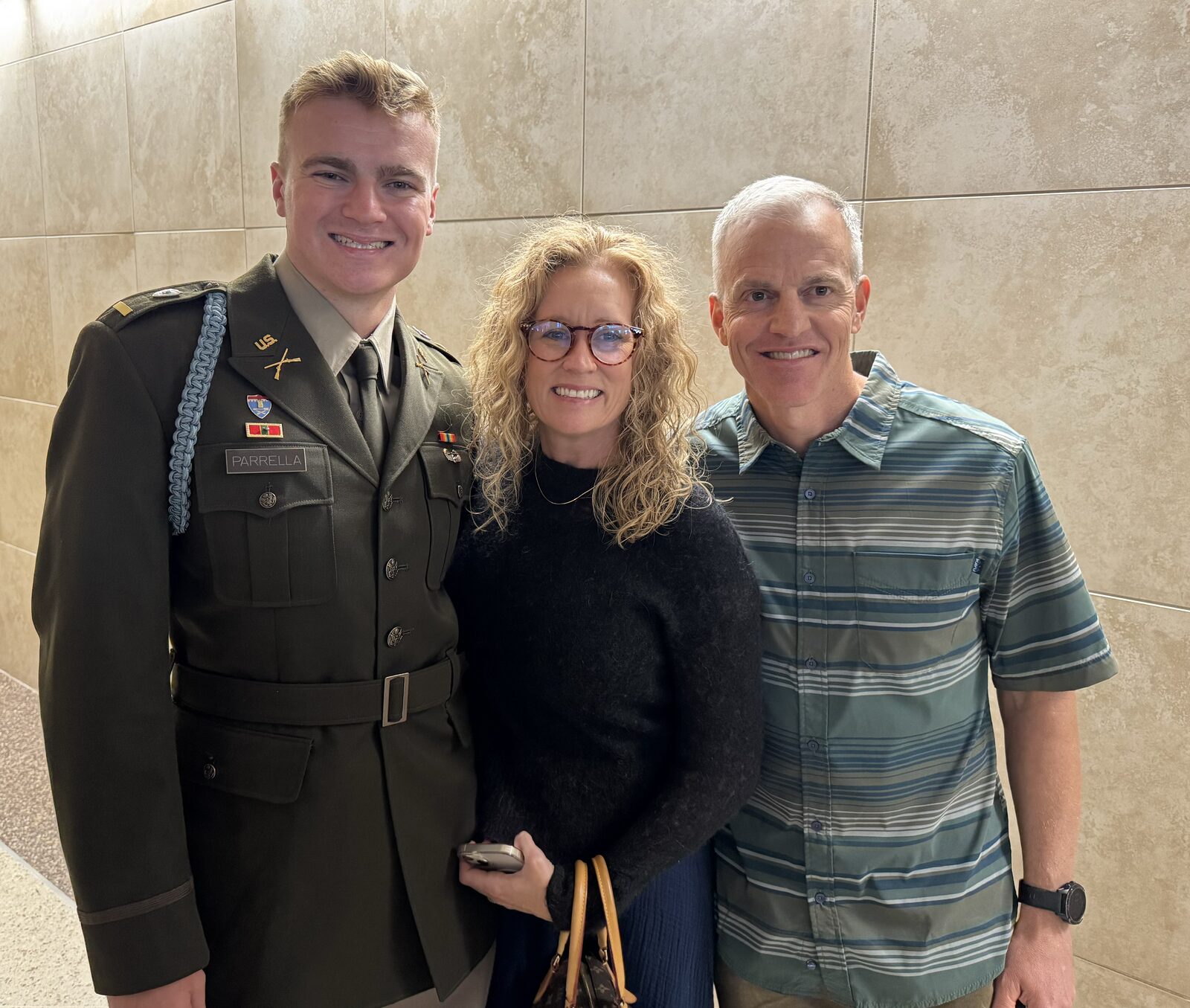 Jennifer and her family with a newly commissioned Army officer
